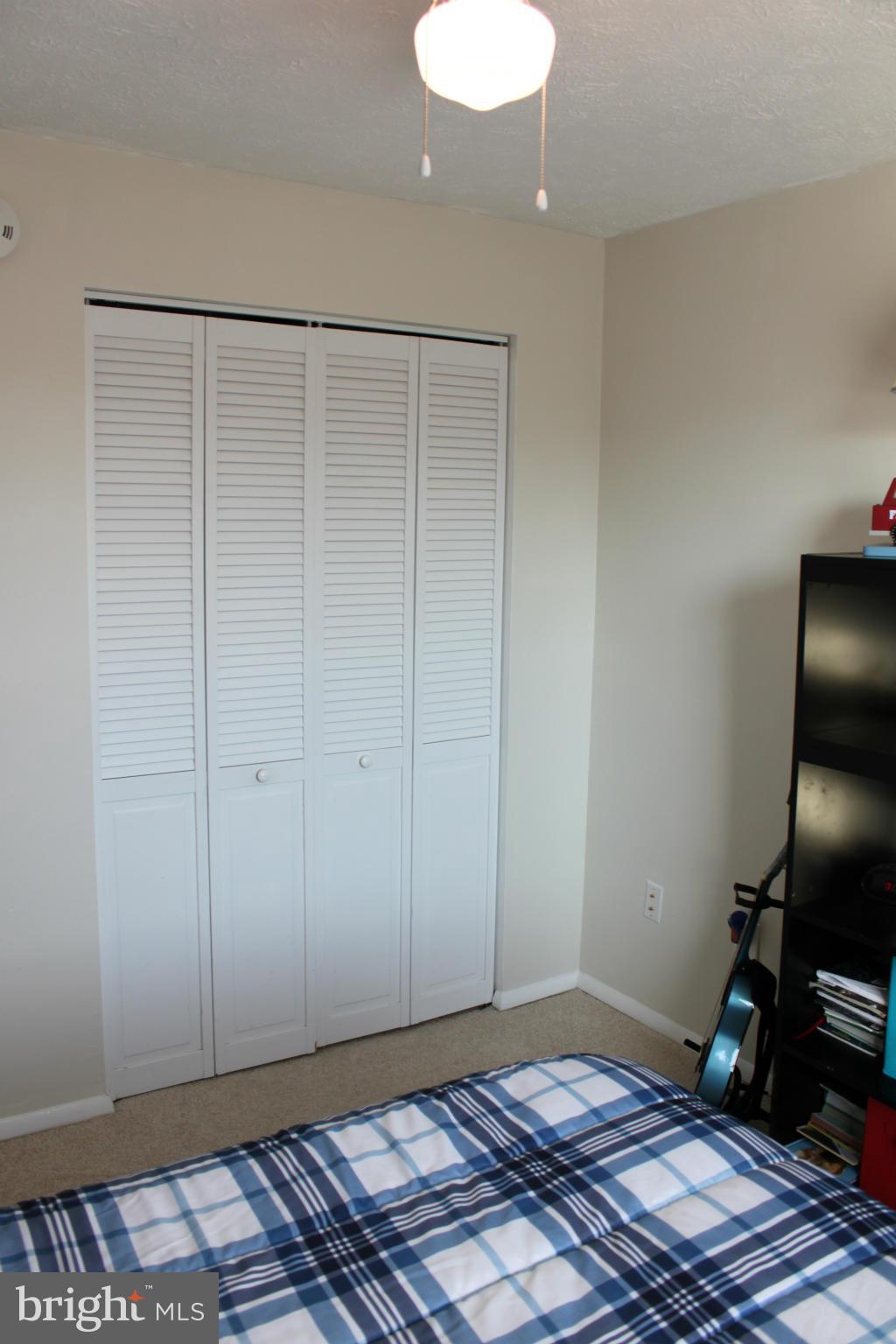 4404 Cub Run Road Chantilly, VA 20151 - Photo 21 of 30 a bedroom with a bed and a flat tv screen on a dresser