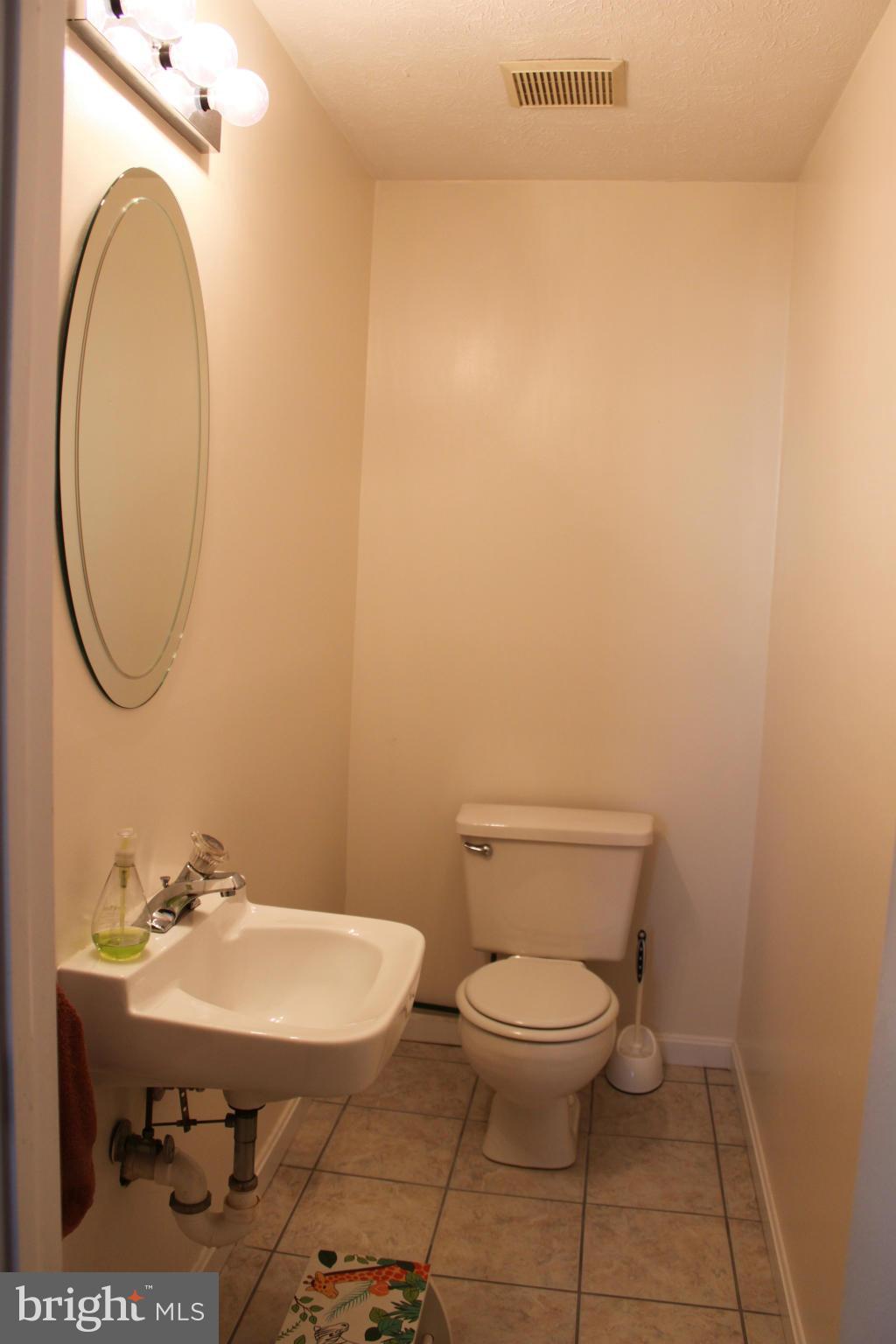 4404 Cub Run Road Chantilly, VA 20151 - Photo 24 of 30 a bathroom with a sink a toilet and a mirror