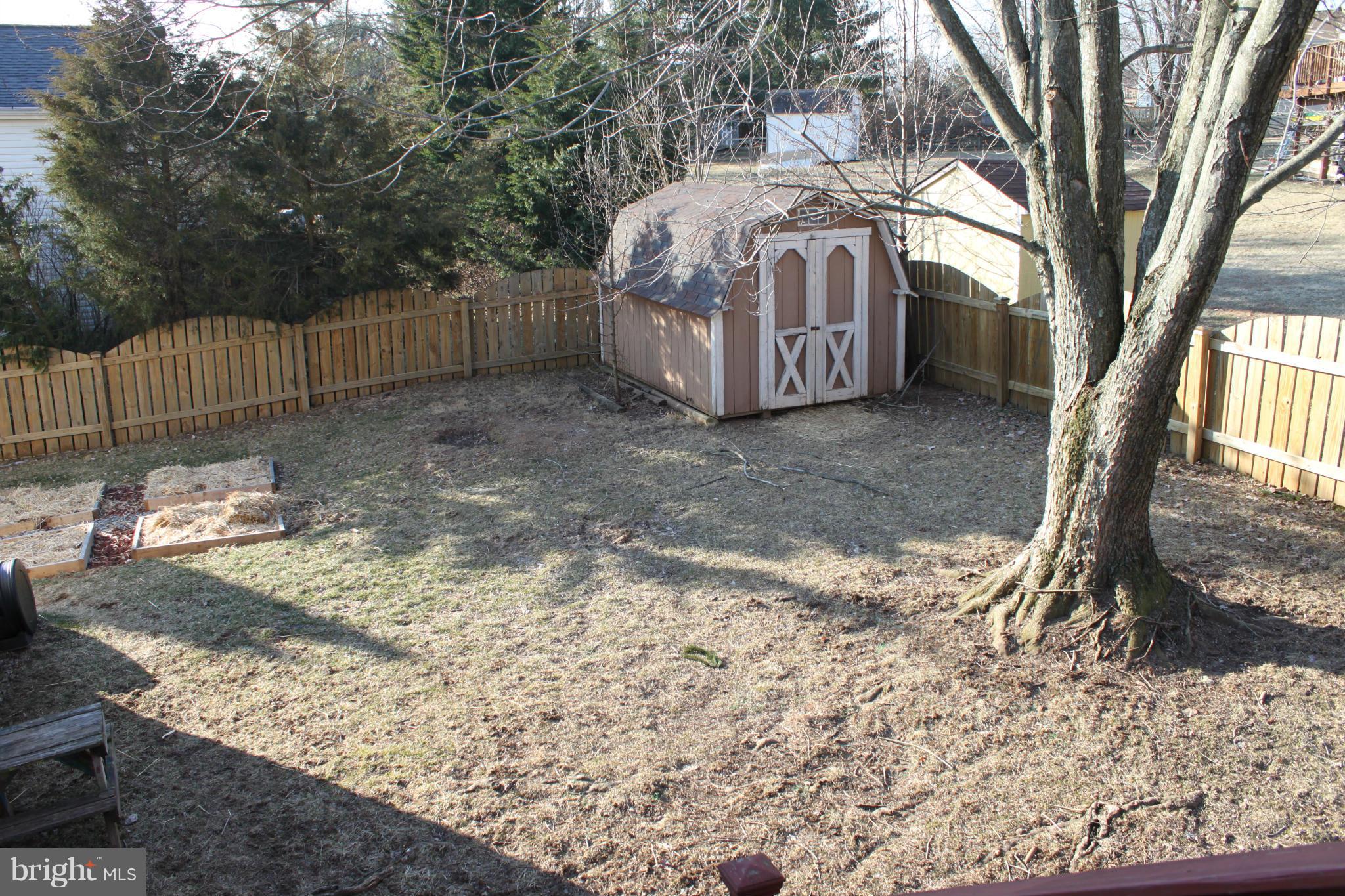 4404 Cub Run Road Chantilly, VA 20151 - Photo 27 of 30 a view of a backyard with large trees and wooden fence