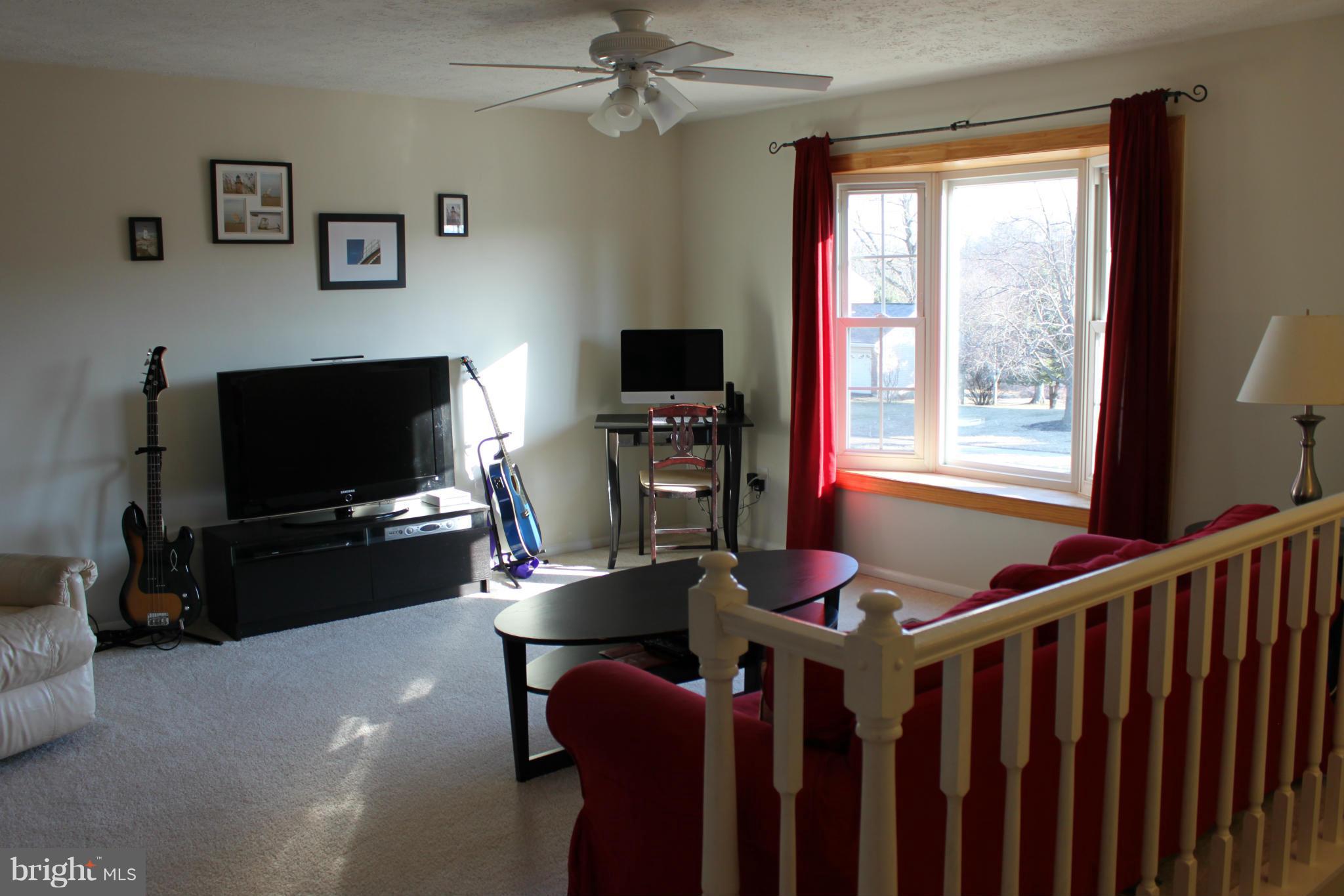 4404 Cub Run Road Chantilly, VA 20151 - Photo 4 of 30 a living room with furniture a flat screen tv and a fireplace