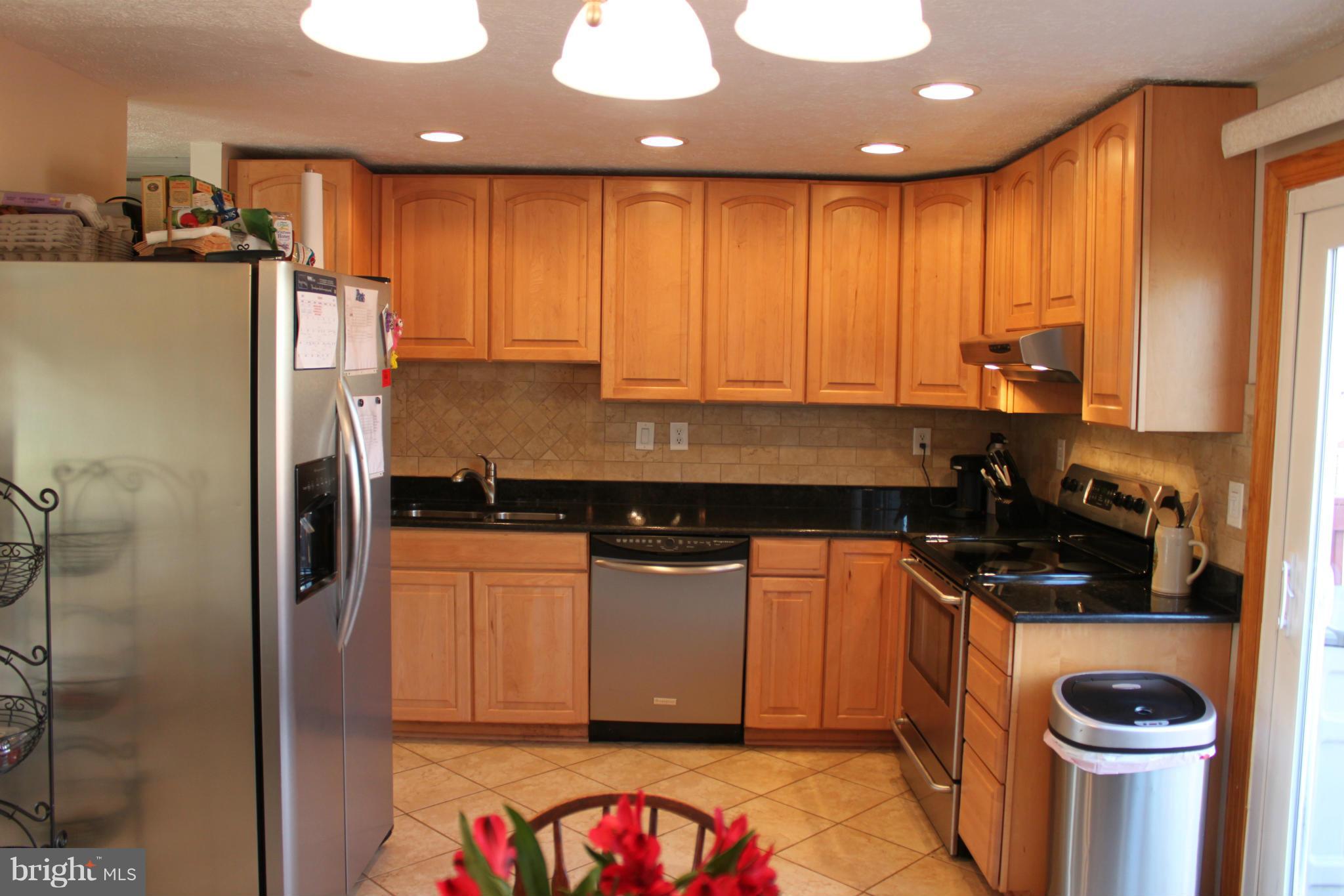 4404 Cub Run Road Chantilly, VA 20151 - Photo 7 of 30 a kitchen with stainless steel appliances granite countertop a refrigerator a stove and a sink