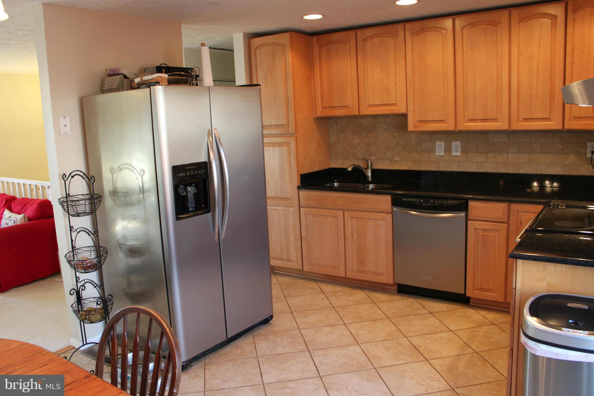 4404 Cub Run Road Chantilly, VA 20151 - Photo 8 of 30 a kitchen with stainless steel appliances granite countertop a refrigerator and a stove top oven