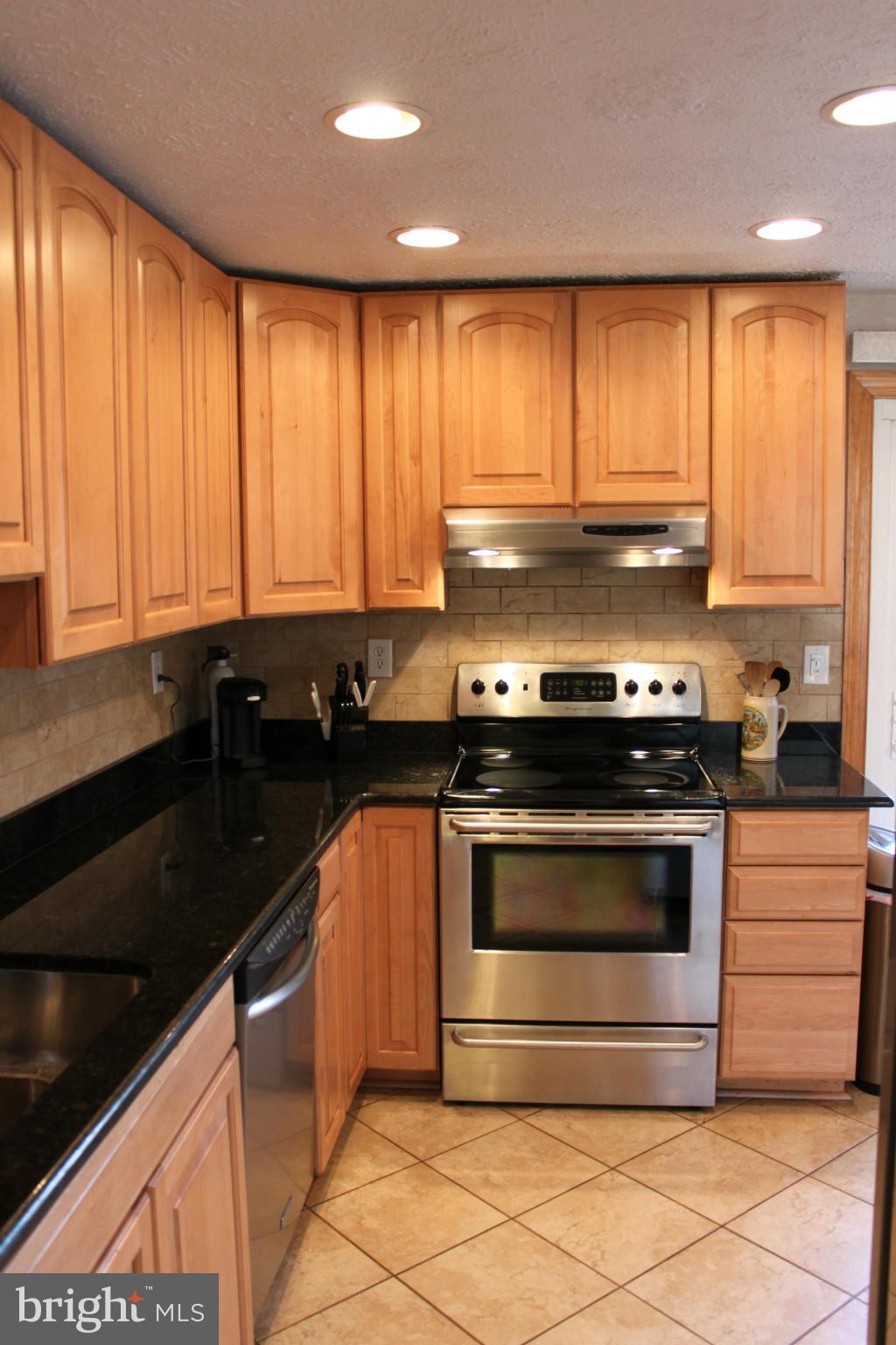 4404 Cub Run Road Chantilly, VA 20151 - Photo 9 of 30 a kitchen with granite countertop a stove and a sink
