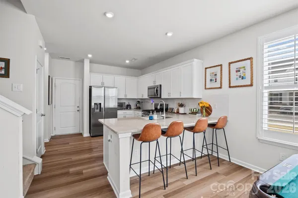 a kitchen with a sink cabinets and wooden floor