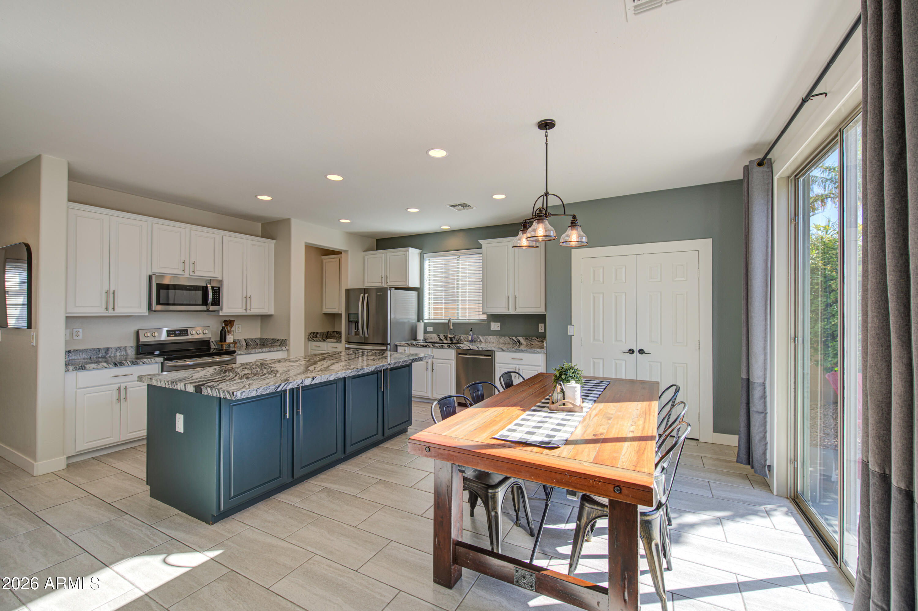 21303 East Alyssa Road Queen Creek, AZ 85142 - Photo 11 of 29 a kitchen with kitchen island a sink counter top space appliances and a center island