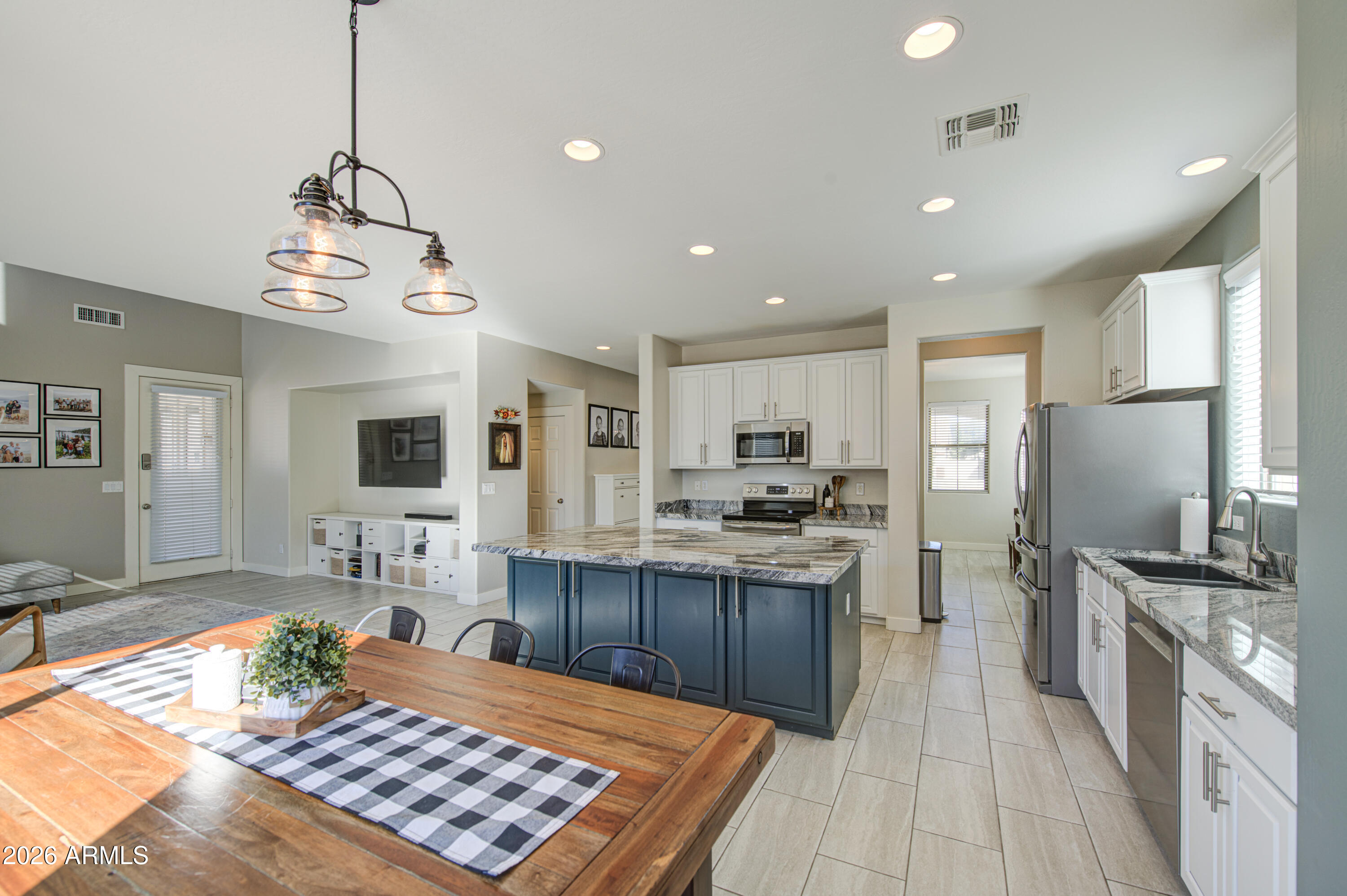 21303 East Alyssa Road Queen Creek, AZ 85142 - Photo 12 of 29 a kitchen with stainless steel appliances granite countertop a sink stove and refrigerator