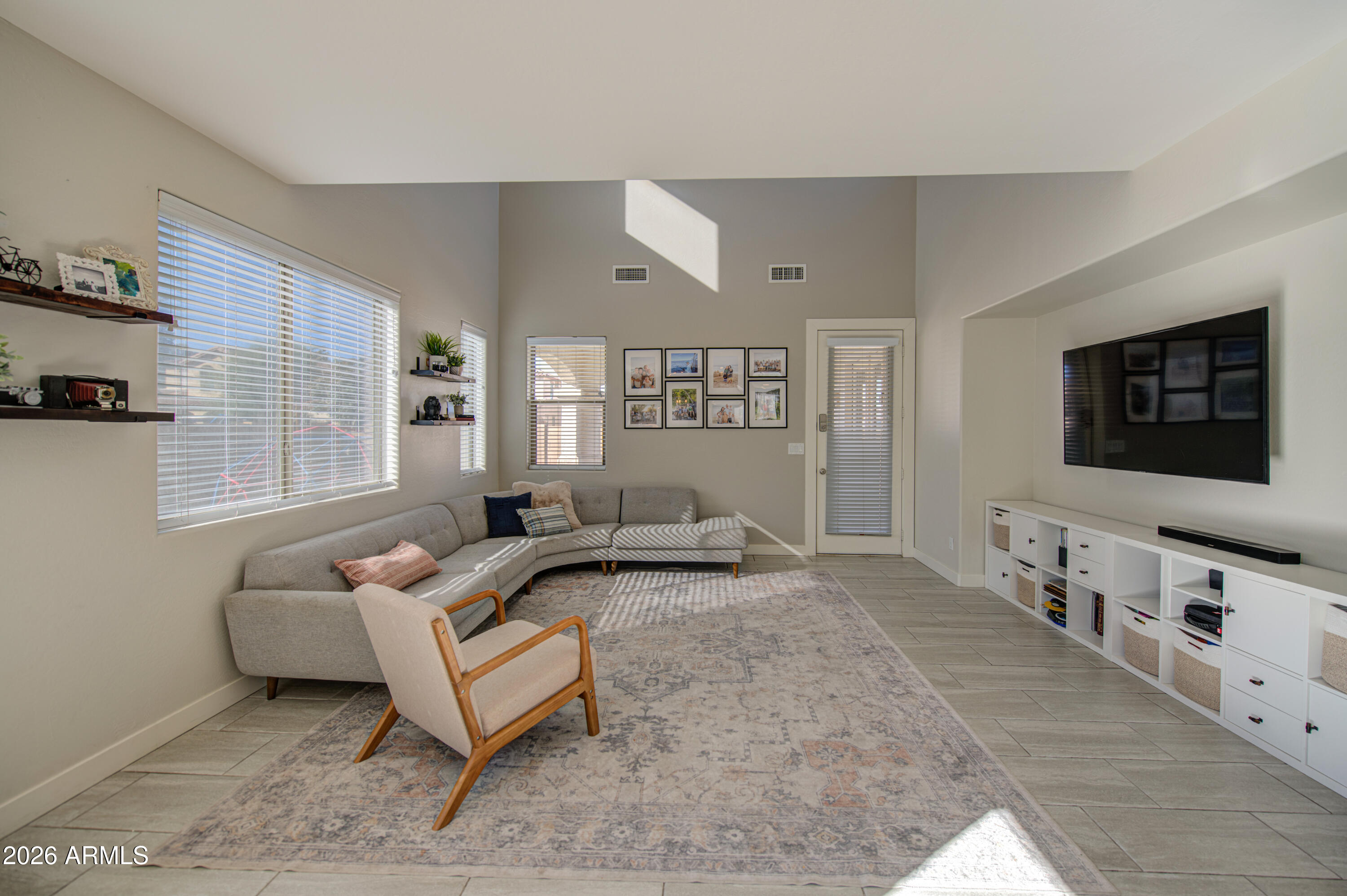 21303 East Alyssa Road Queen Creek, AZ 85142 - Photo 15 of 29 a living room with furniture and a flat screen tv