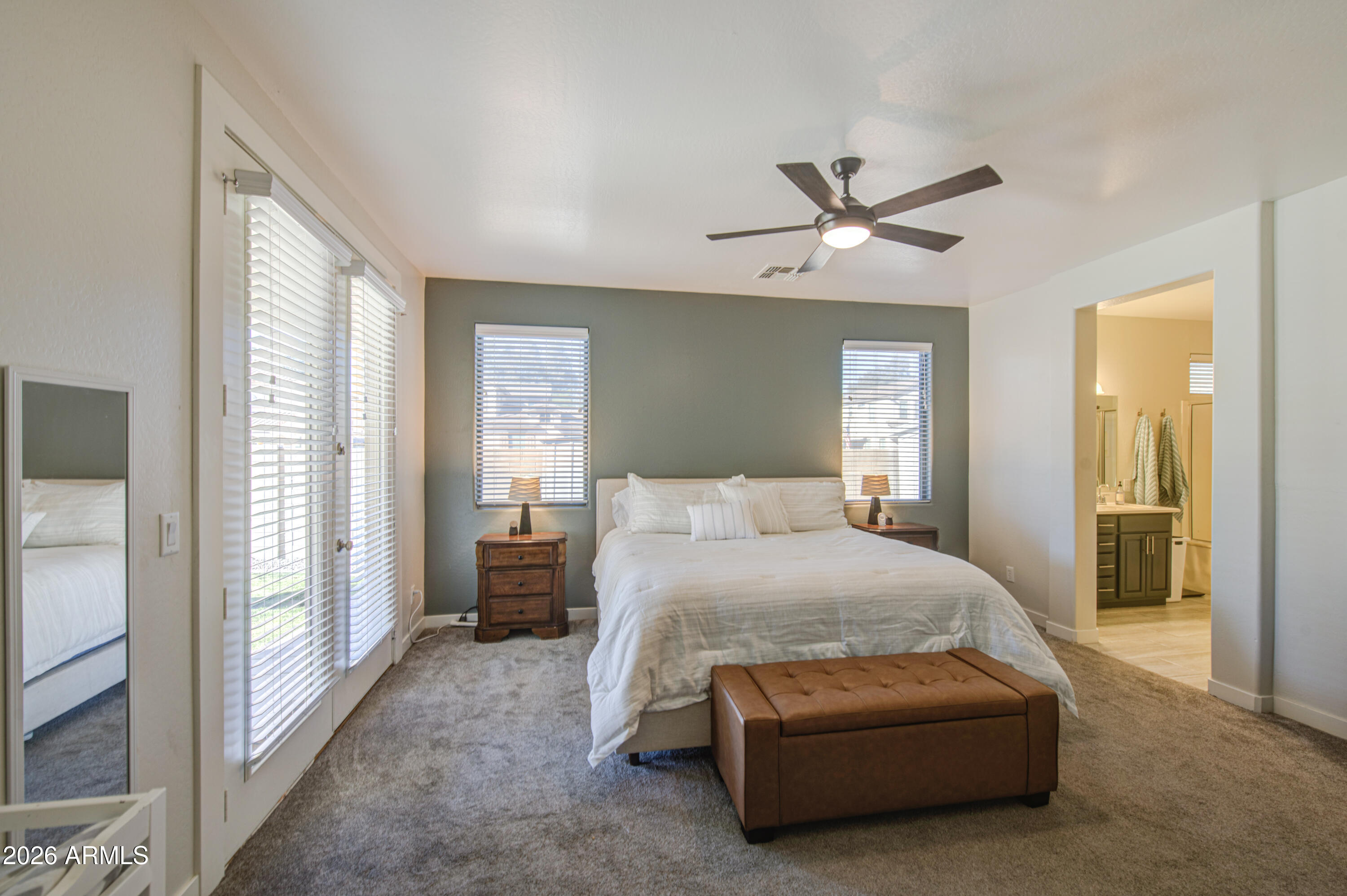 21303 East Alyssa Road Queen Creek, AZ 85142 - Photo 17 of 29 a bedroom with a large bed and a chandelier fan
