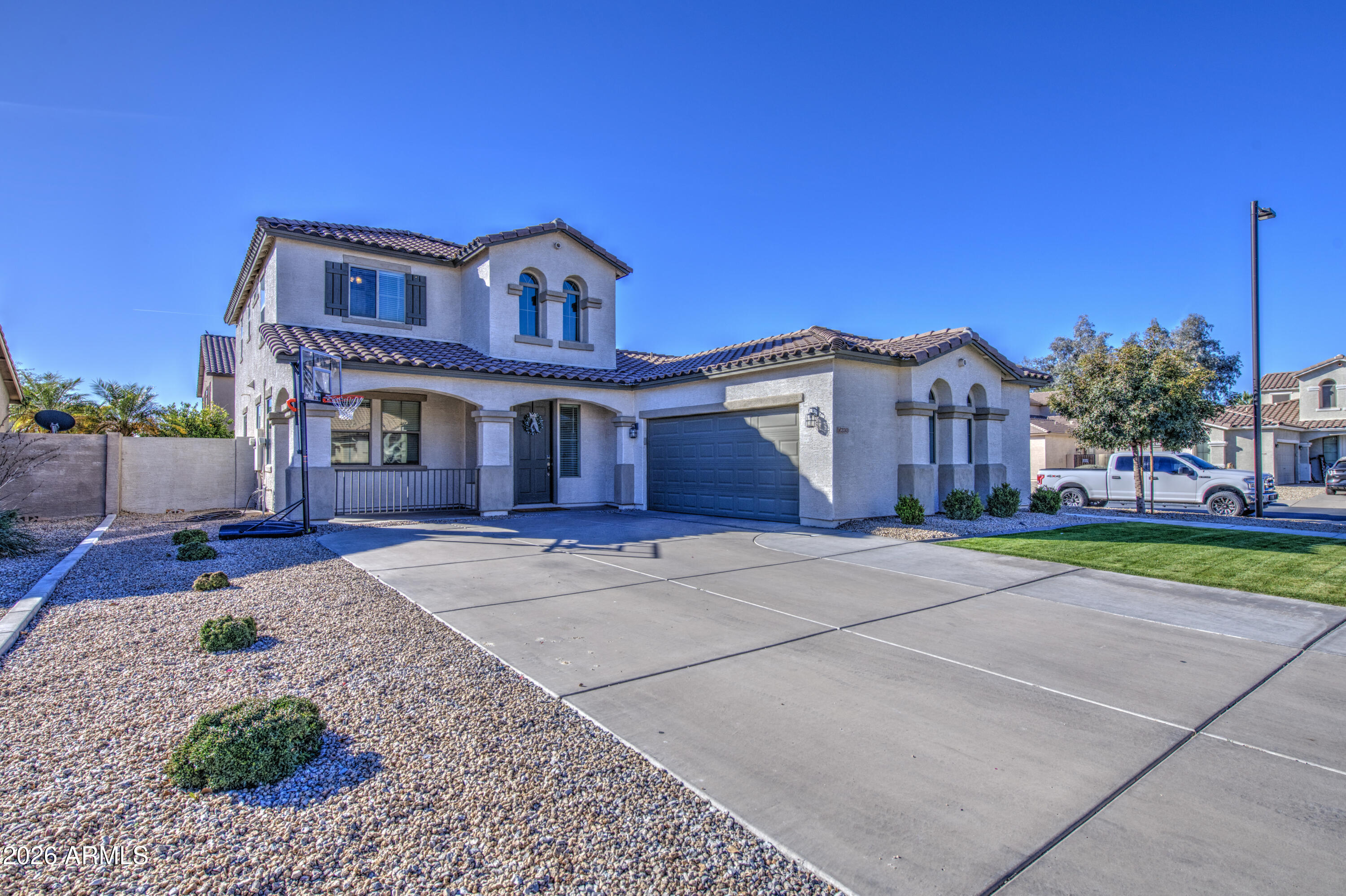 21303 East Alyssa Road Queen Creek, AZ 85142 - Photo 2 of 29 a view of a big house with a big yard and large tree