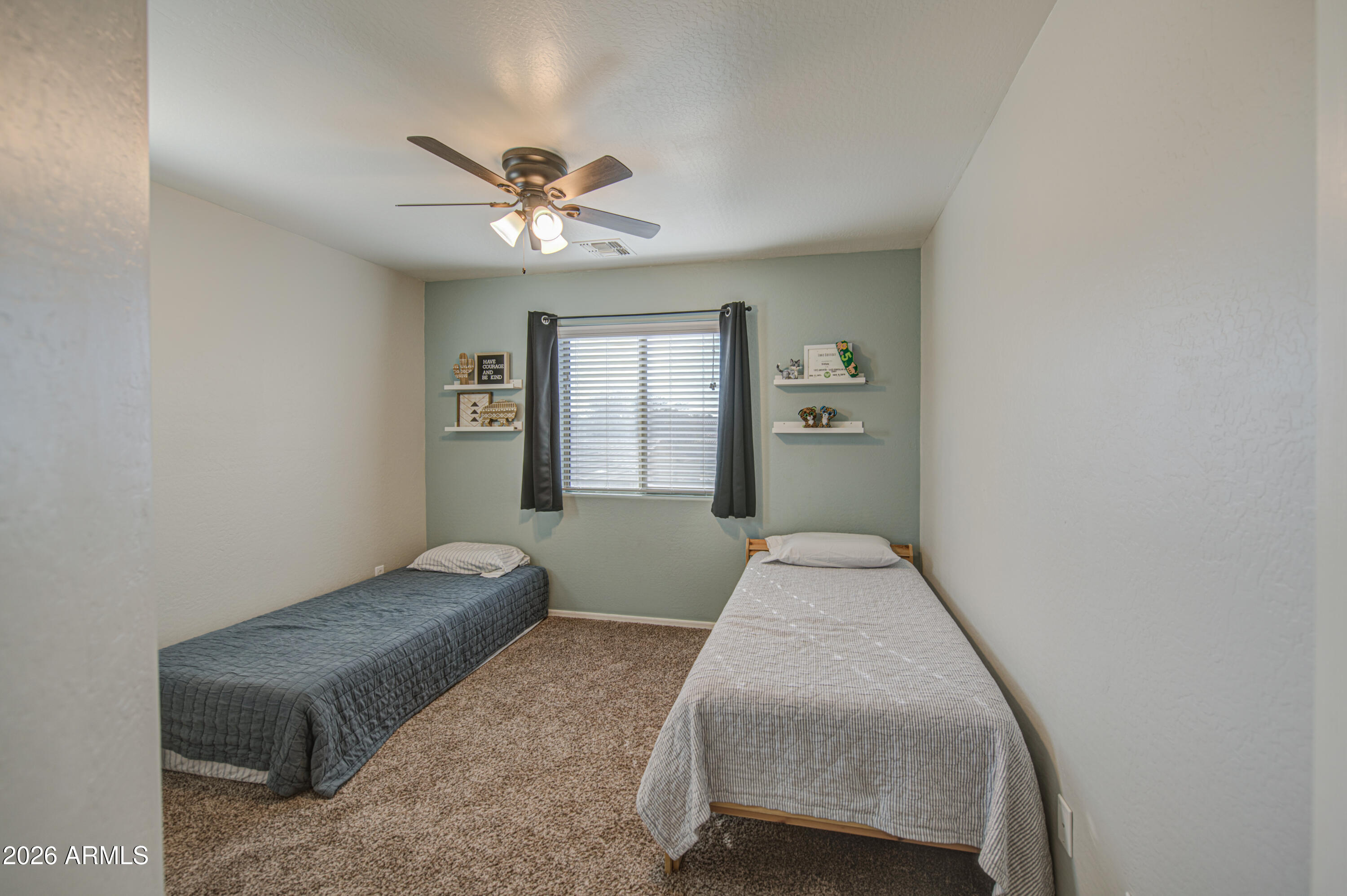 21303 East Alyssa Road Queen Creek, AZ 85142 - Photo 23 of 29 a bedroom with a bed and a chandelier