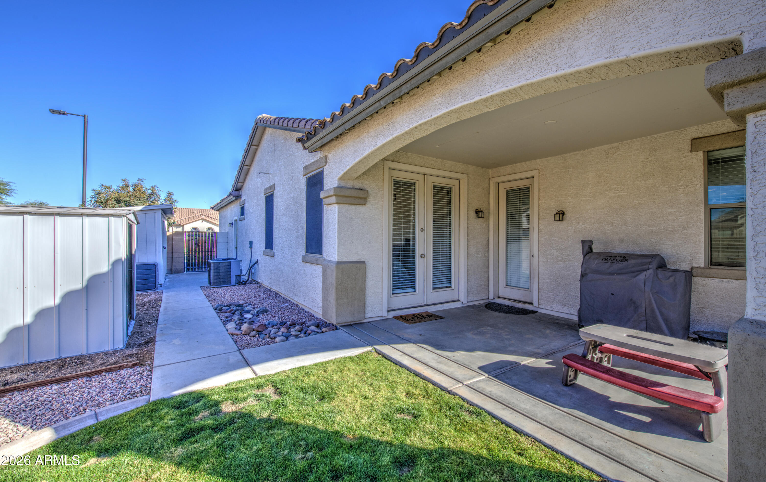 21303 East Alyssa Road Queen Creek, AZ 85142 - Photo 28 of 29 a view of a backyard with chairs and wooden fence