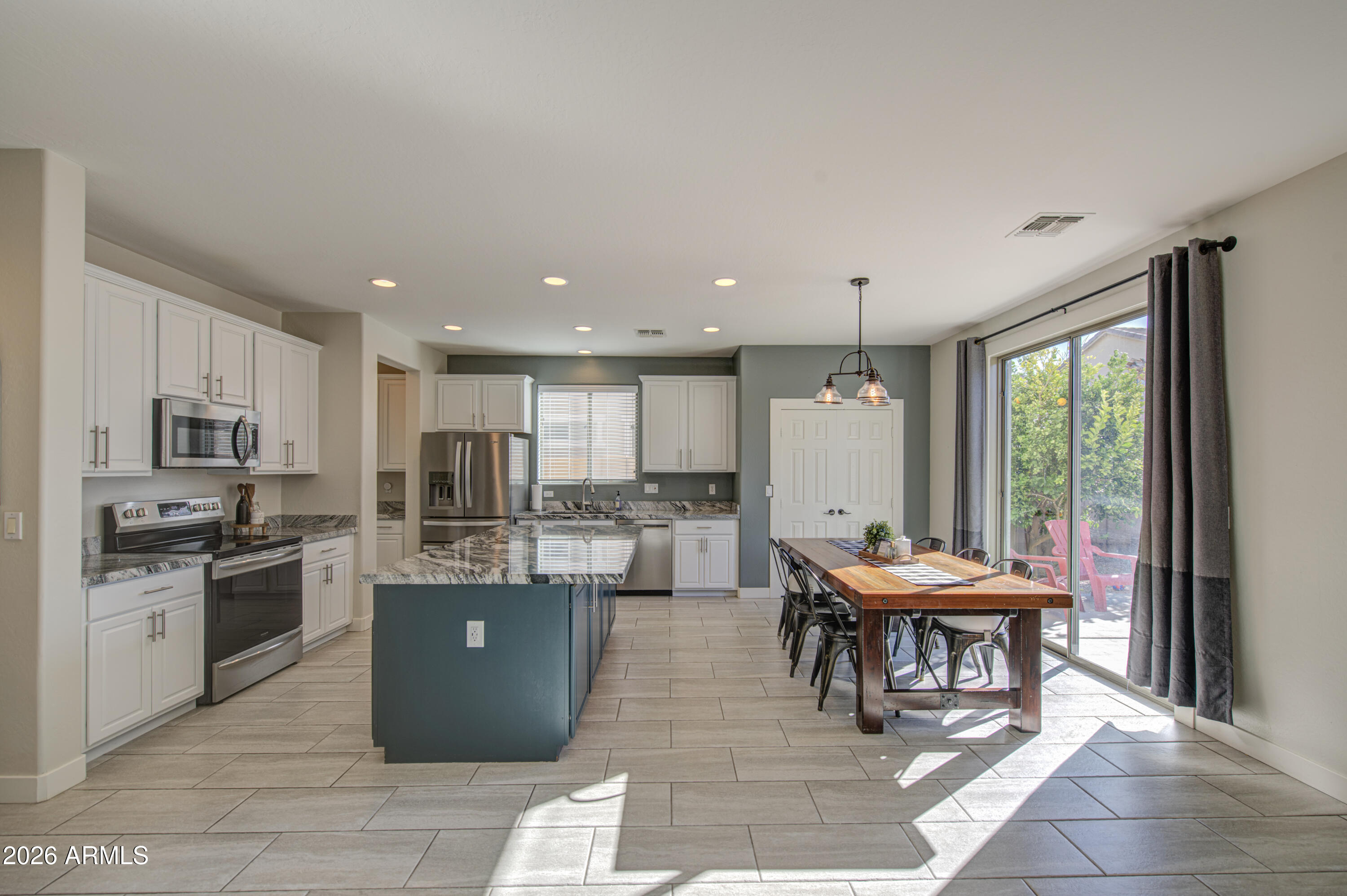21303 East Alyssa Road Queen Creek, AZ 85142 - Photo 9 of 29 a kitchen with a table and chairs in it