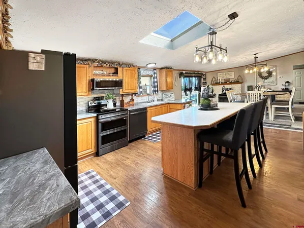 a large kitchen with a table and chairs