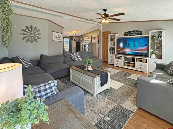a bedroom with a bed and a flat tv screen on dresser
