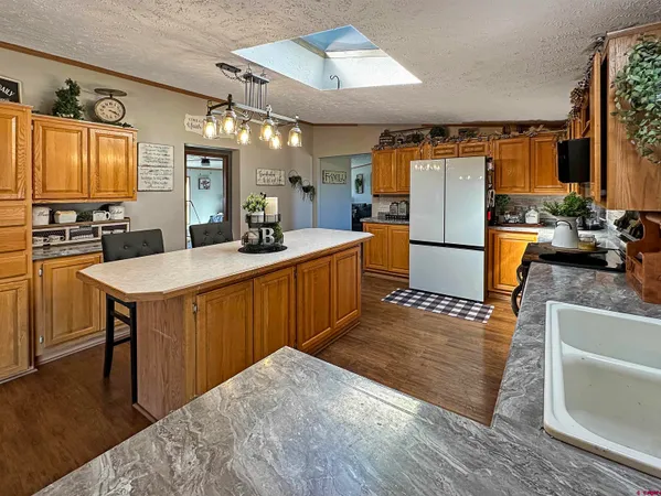 a kitchen with sink refrigerator and cabinets