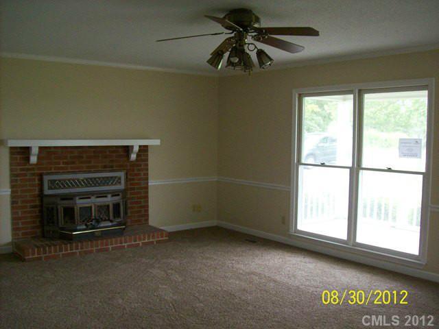 201 Owens Road York, SC 29745 - Photo 2 of 7 a view of an empty room with a fireplace and a window