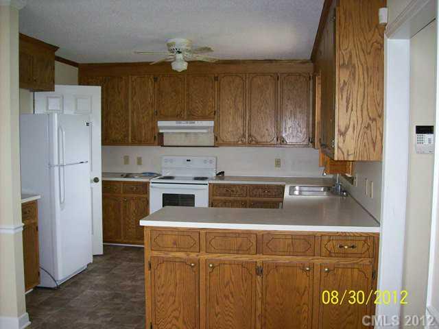 201 Owens Road York, SC 29745 - Photo 4 of 7 a kitchen with a stove a refrigerator and a sink