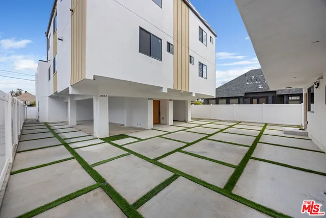 a view of kitchen with wooden floor and electronic appliances