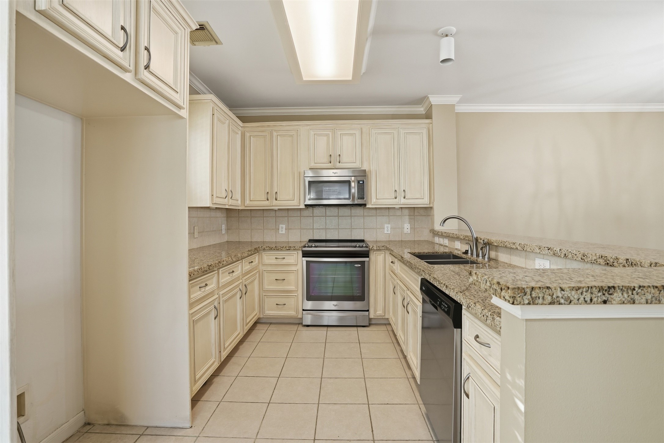 1809 Gillette Street Houston, TX 77019 - Photo 14 of 35 a kitchen with stainless steel appliances granite countertop a stove and a sink