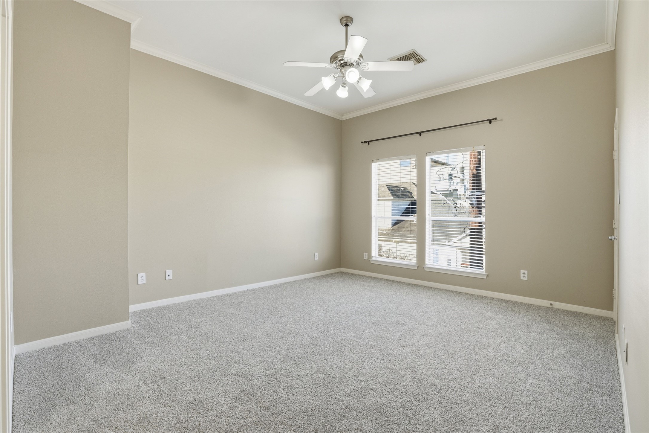 1809 Gillette Street Houston, TX 77019 - Photo 20 of 35 an empty room with windows and chandelier fan