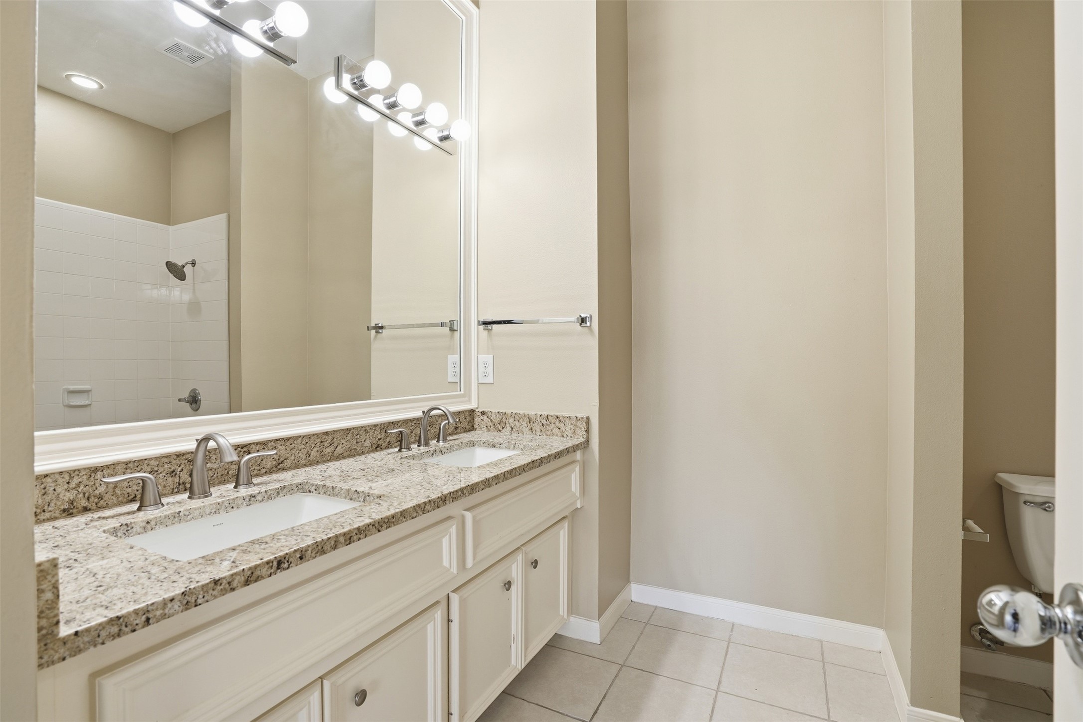 1809 Gillette Street Houston, TX 77019 - Photo 21 of 35 a bathroom with a granite countertop sink and a mirror