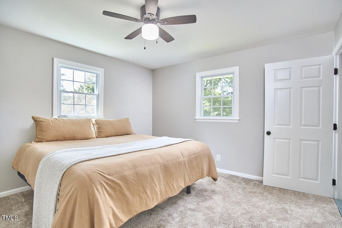 4103 Cheek Road Durham, NC 27704 - Photo 25 of 34 a bedroom with a large bed and a window