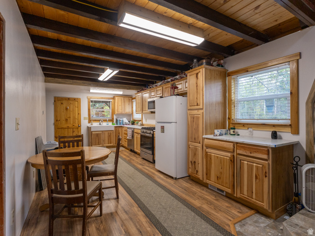 5082 Pine Crest Road Evanston, UT 82930 - Photo 10 of 25 Kitchen featuring natural wood cabinetry and exposed wood ceiling beams