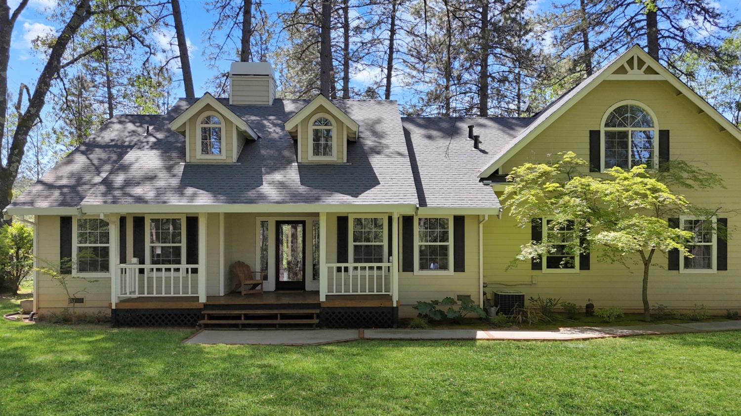 1795 Volley Road Meadow Vista, CA 95722 - Photo 1 of 34 a view of a brick house with a yard and large trees