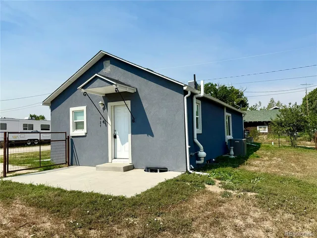 a front view of house with yard outdoor seating and barbeque oven