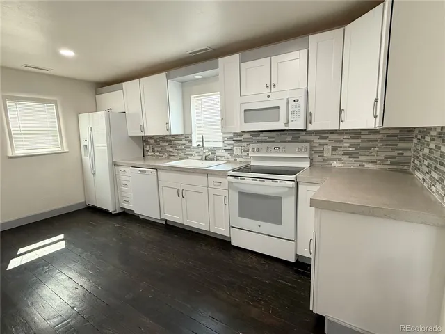 a view of an empty room and wooden floor