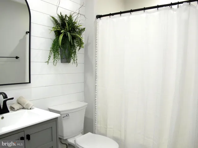 a bathroom with a sink toilet and a mirror