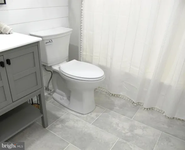 a white toilet sitting next to a white sink