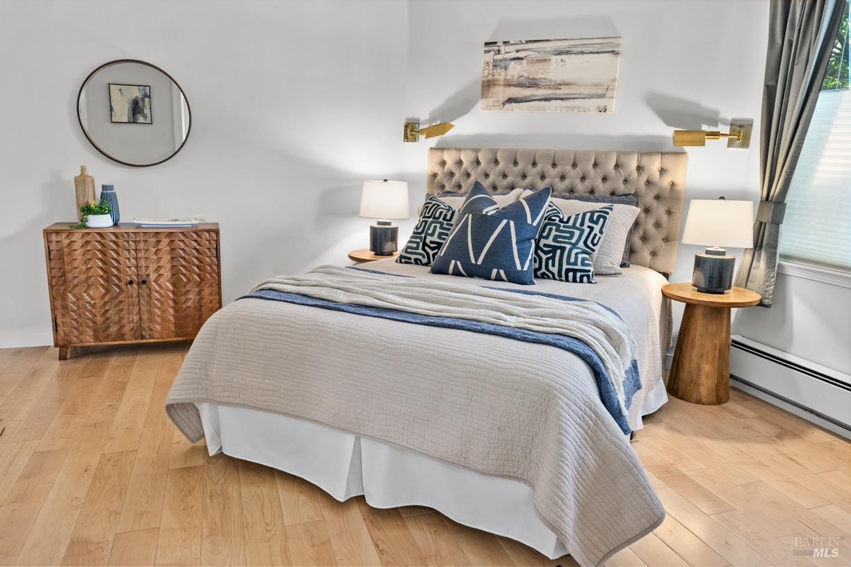 110 Seminary Drive, Unit 1A Mill Valley, CA 94941 - Photo 11 of 27 a bedroom with a bed and a lamp on dresser