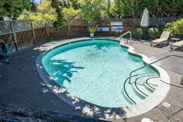 a view of a swimming pool with a patio
