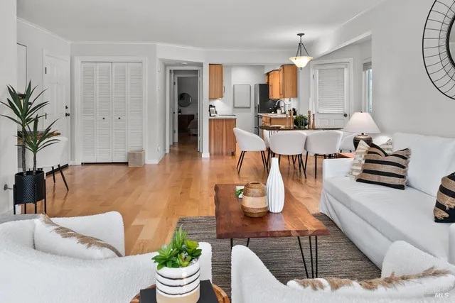a living room with kitchen island furniture and a view of kitchen