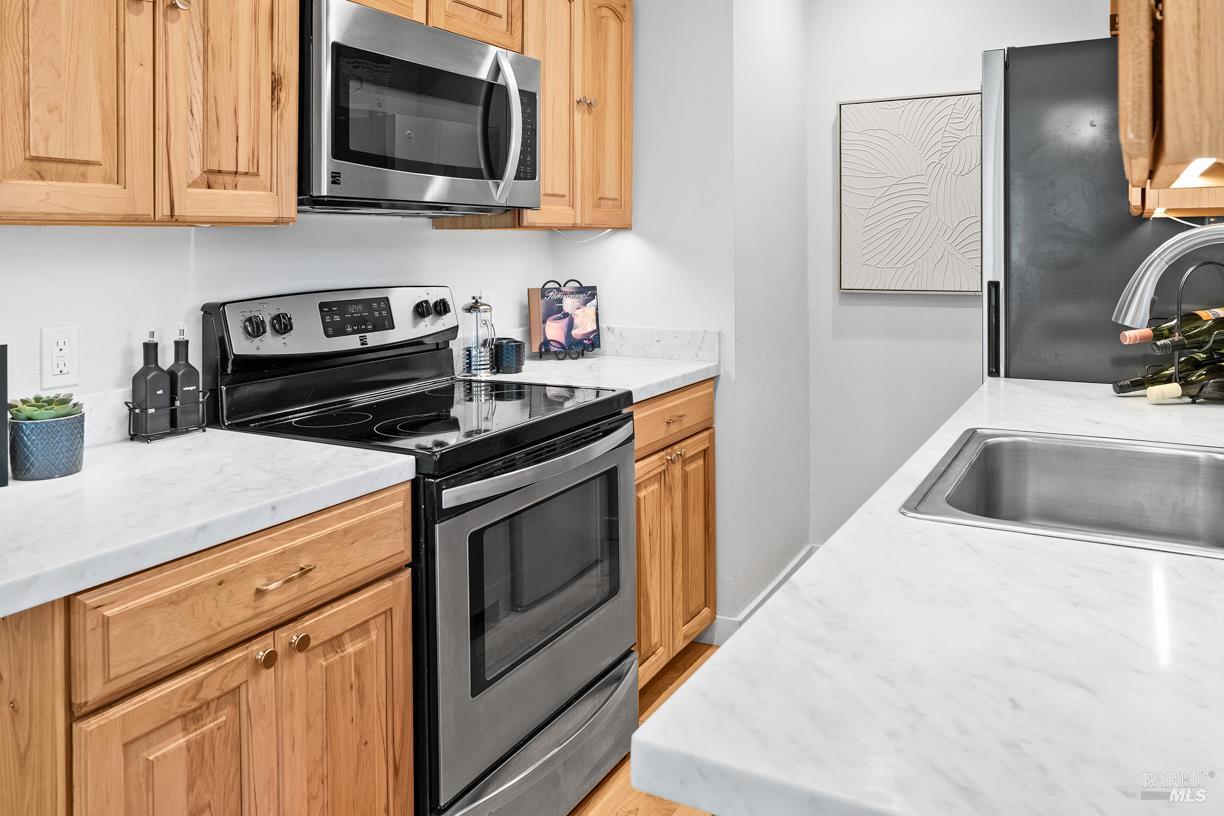 110 Seminary Drive, Unit 1A Mill Valley, CA 94941 - Photo 7 of 27 a kitchen with stainless steel appliances granite countertop a sink stove and microwave