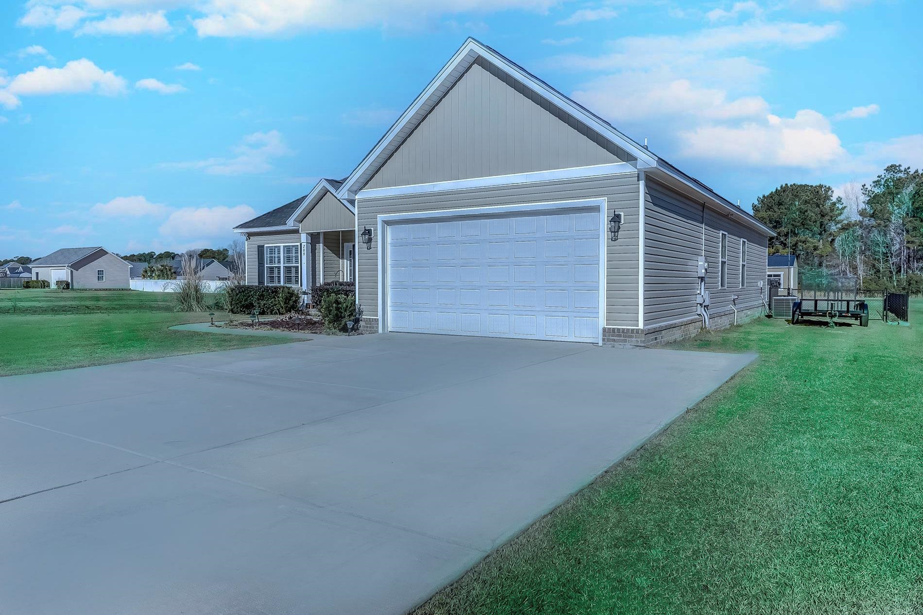 209 Highmeadow Lane Aynor, SC 29511 - Photo 2 of 40 View of front of house featuring a front yard, driveway, and an attached garage