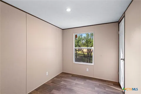 a view of hallway with wooden floor