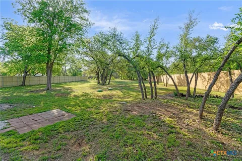a view of a wooden house with a yard