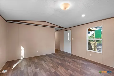 a kitchen with a refrigerator and a stove top oven