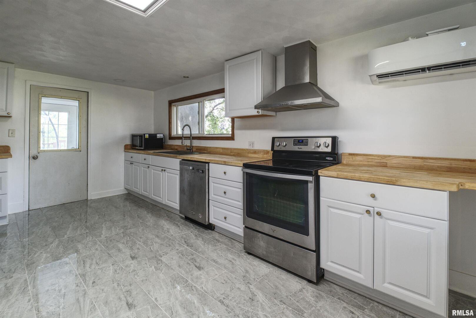 828 10th Avenue Fulton, IL 61252 - Photo 12 of 34 a kitchen with stainless steel appliances granite countertop a stove and a sink