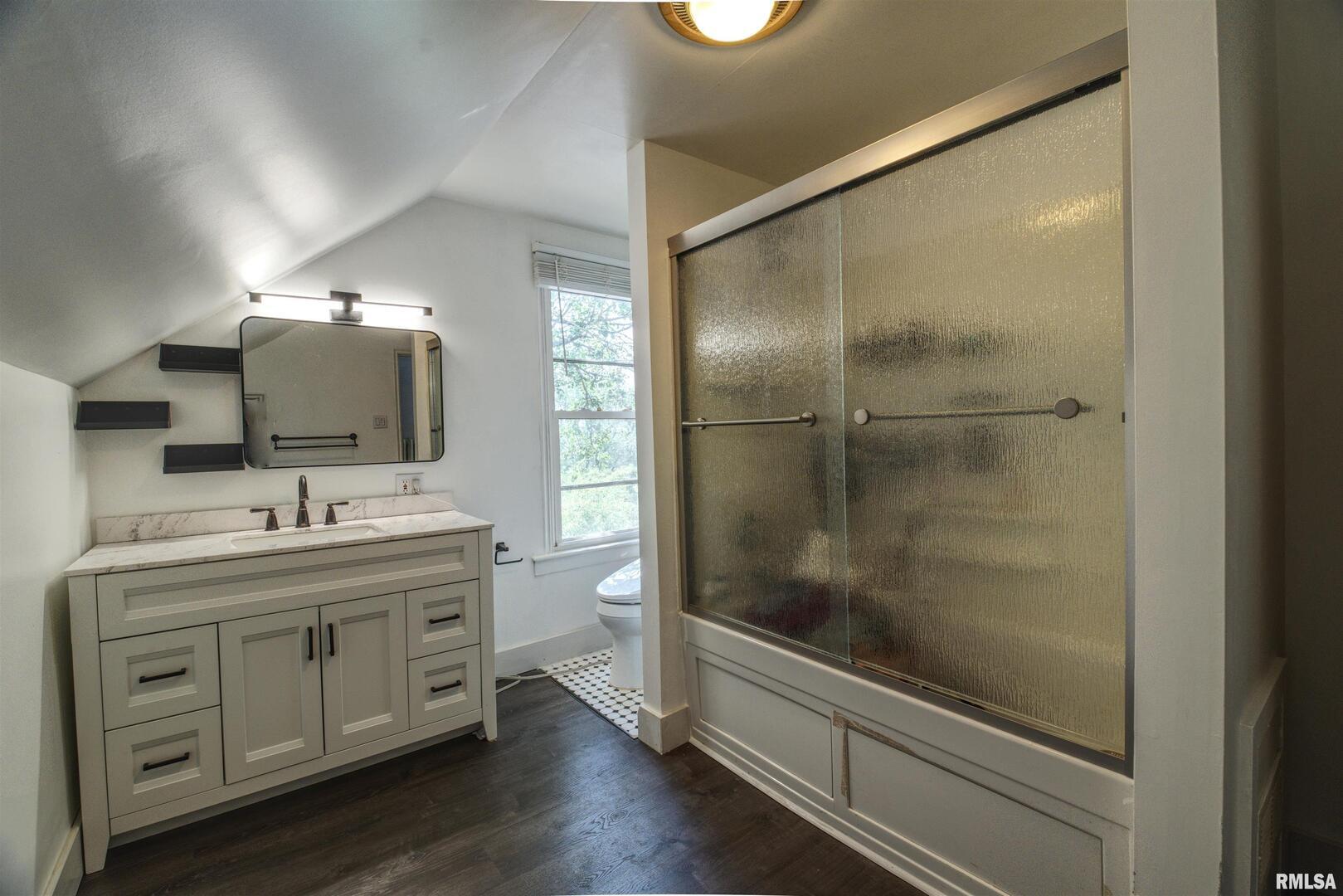 828 10th Avenue Fulton, IL 61252 - Photo 22 of 34 a bathroom with a double vanity sink mirror and shower