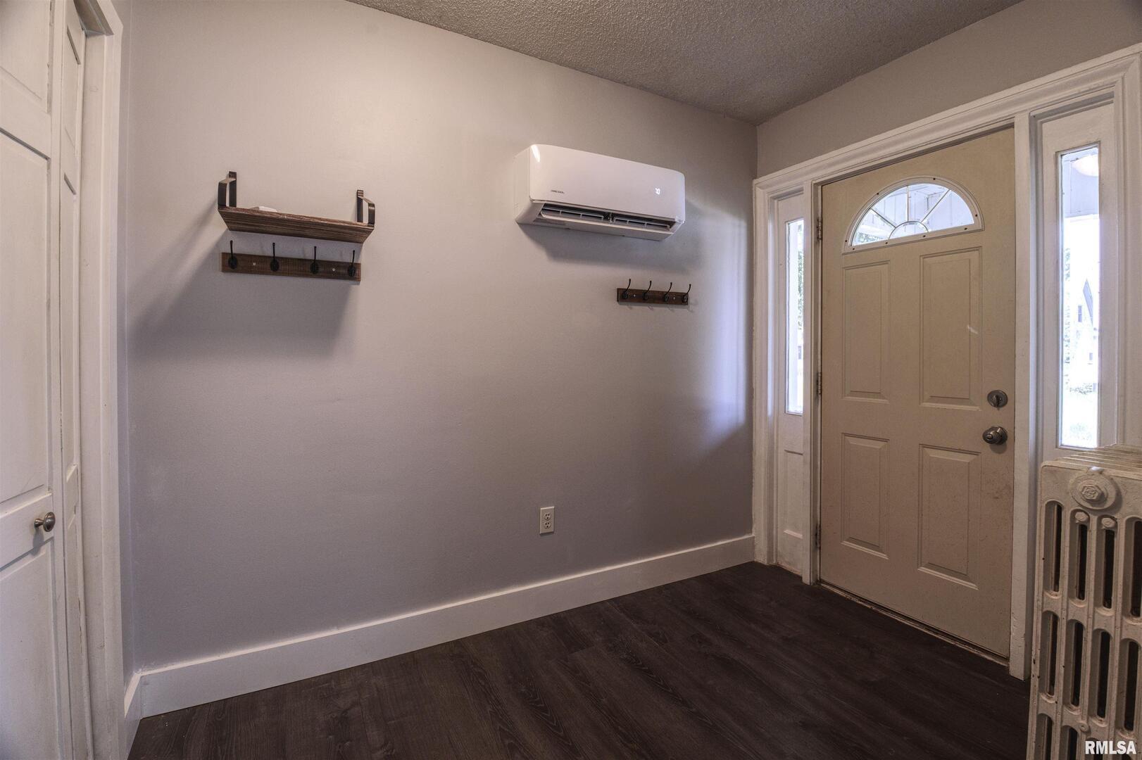 828 10th Avenue Fulton, IL 61252 - Photo 7 of 34 an empty room with wooden floor closet and windows