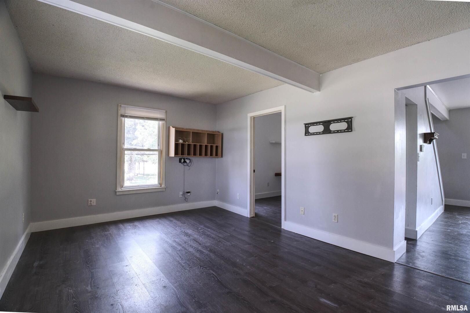 828 10th Avenue Fulton, IL 61252 - Photo 8 of 34 an empty room with wooden floor and windows