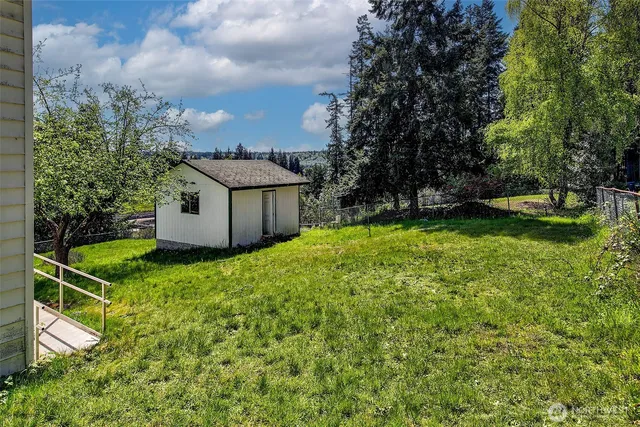 an aerial view of a house with swimming pool garden and patio