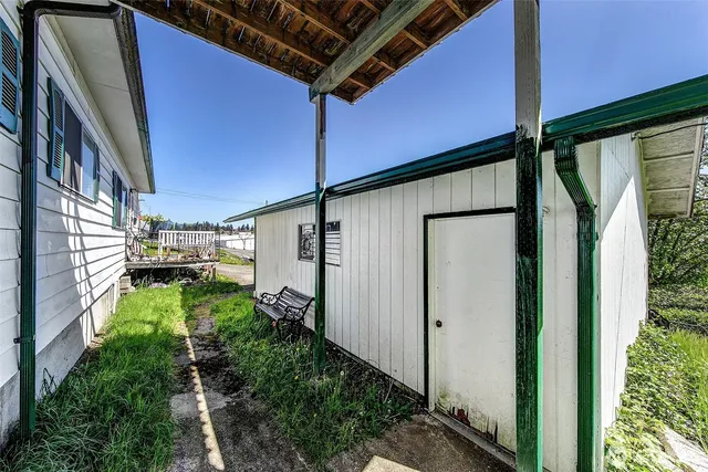 a view of a chairs and table in backyard of the house