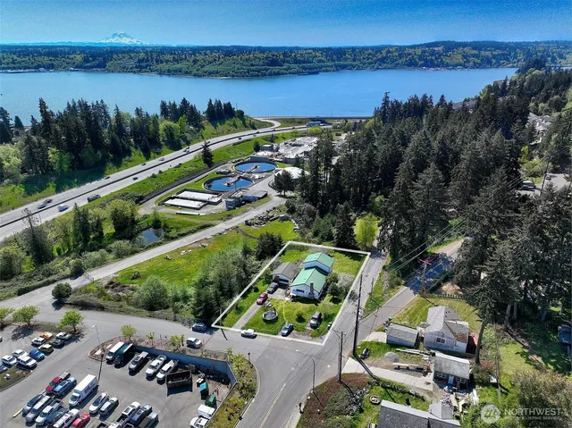 an aerial view of a house with a garden and lake view