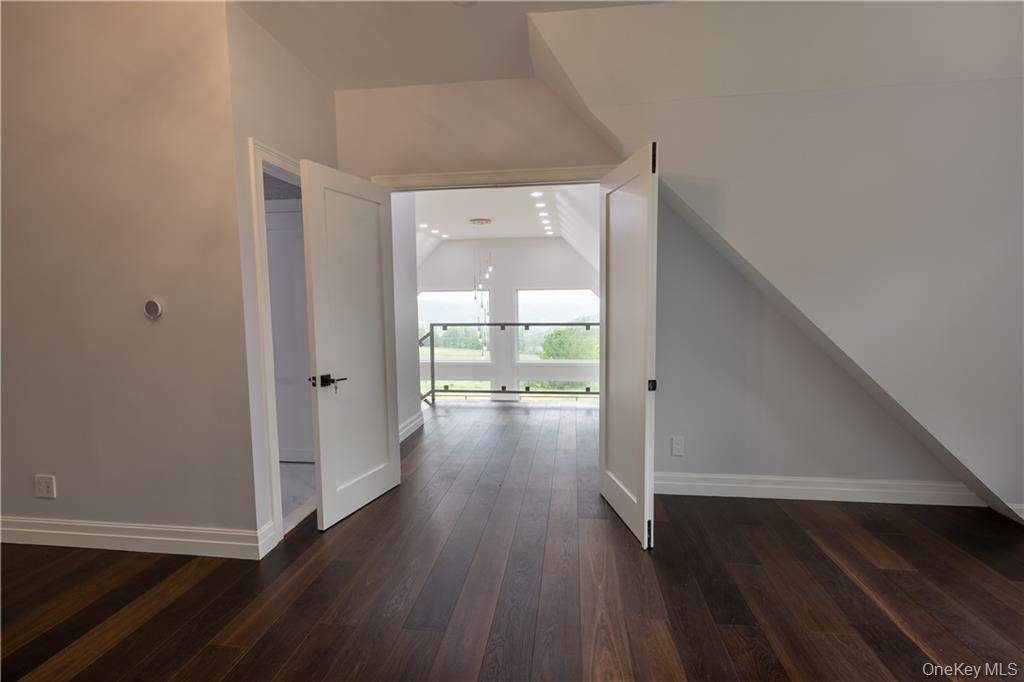 274 Reservoir Hill Road Norwich, NY 13815 - Photo 23 of 44 a view of a hallway view with wooden floor and staircase