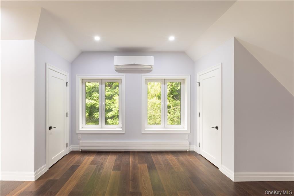 274 Reservoir Hill Road Norwich, NY 13815 - Photo 26 of 44 an empty room with wooden floor and windows