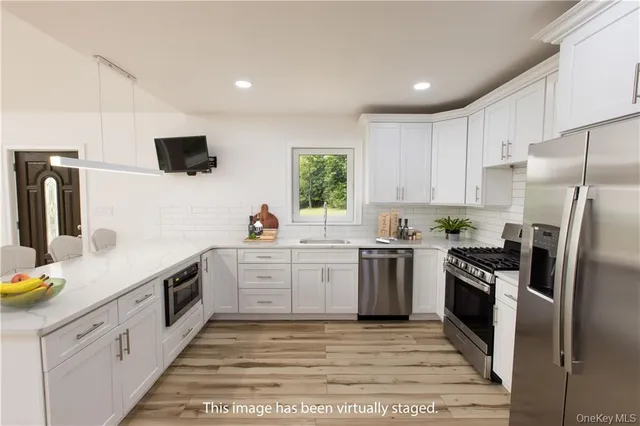 a kitchen with a sink stainless steel appliances and cabinets
